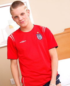 Englishlads.com: Tommie lets it all hang out of his sports kit, then spreads his legs and fingers his smooth hole